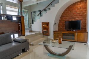 a living room with a couch and a glass table at Galerias Oaxaca Suites in Oaxaca City