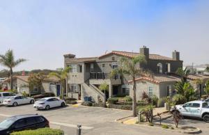 a group of houses with cars parked in a parking lot at Pacific Plaza #109 - Seaside Setting - 1BdrmUp-K-QSofa in Oceano