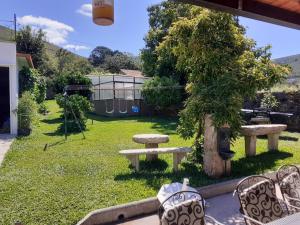 a garden with a bench and a tree and a playground at Casa do Galego 