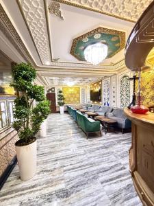 a hotel lobby with chairs and a chandelier at Basilic Boutique Hotel in Bukhara