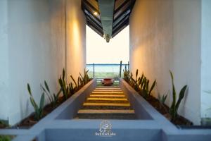 a staircase leading up to a building with a view of the ocean at Sunrise Lake Resort in Polonnaruwa