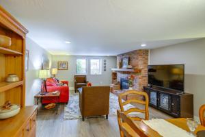 a living room with a fireplace and a red couch at Central to Everything! Missoula Stay with Courtyard in Community Medical Center Heliport