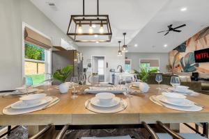 a dining room and living room with a large wooden table at Brand New Cozy FirePit Home Near Fort Moore in Columbus