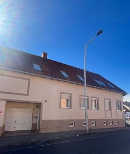a building with two garage doors and a street light at ORIGO Kőszeg in Kőszeg +35 photos