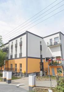 a building with a yellow and white building at Sweet Home Ślęża Mountains in Sobótka