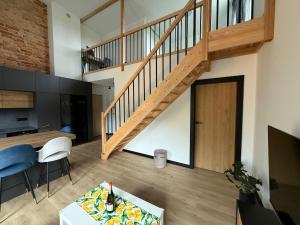 a living room with a staircase and a table at Sweet Home Ślęża Mountains in Sobótka +11 photos