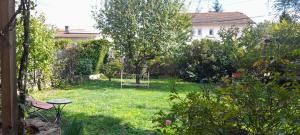 a yard with a garden with a swing at Chambre privée chez l'habitant in Roanne