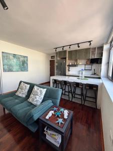 a living room with a couch and a kitchen at Exclusive King Suite All inclusive amenities Miraflores Center in Lima +3 photos