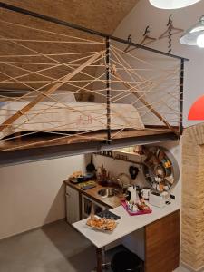a loft bed in a kitchen with a sink at Le tre scimmiette in Lanciano +25 photos