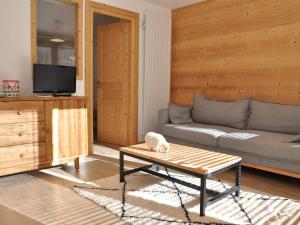 a living room with a couch and a table at Appartement lumineux avec terrasse, 2 chambres, parking et cave - La Chapelle-d'Abondance - FR-1-692-3 in La Chapelle-dʼAbondance