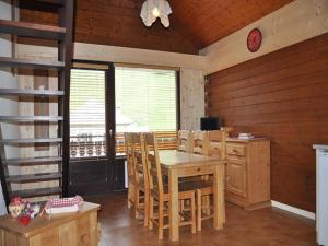 a dining room with a wooden table and chairs at Charmant appartement familial avec mezzanine et balcon en centre-ville - FR-1-692-4 in La Chapelle-dʼAbondance
