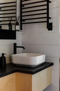 a white sink on a counter in a bathroom at Cabin N1 Les Grand'Pares Lake view Jacuzzi in Saint-Aimé-Du-Lac-des-Îles