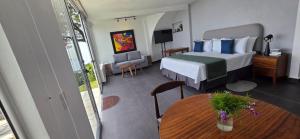 a bedroom with a bed and a table in a room at Hotel Finca Campo Bello in Cerro Verde +29 photos