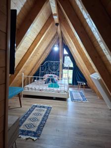 a bedroom with a bed in a attic at Cabana 3 Stejari Maramureș in Călineşti +104 photos