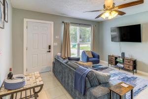 a living room with a couch and a tv at Mins to Beaches and HCA Hospital Fort Pierce Home in Fort Pierce