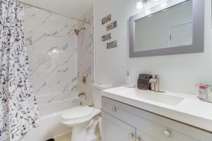 a bathroom with a sink and a toilet and a shower at Mins to Beaches and HCA Hospital Fort Pierce Home in Fort Pierce +16 photos