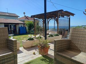 a gazebo with chairs and plants in a yard at Garden House in Sanremo