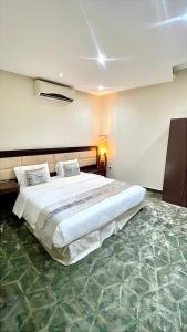 a bedroom with a large bed in a room at Quiet Rooms 12 in Riyadh