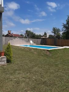 a swimming pool in a yard next to a fence at La Orlinda in Potrero de Garay