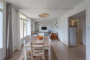 a kitchen and dining room with a table and chairs at Loft des Crêtes vue mer in La Ciotat