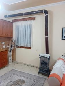 a living room with a fireplace and a stove at Villa Gimi in Gjirokastër +19 photos