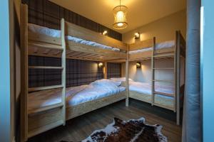 a room with three bunk beds in it at 3 Vallées access & cycling Cosy 4 to 6 guests in Orelle