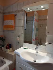 a bathroom with a white sink and a mirror at Dora's Home in Pramanta +23 photos