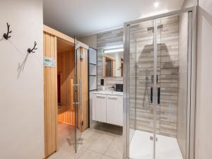 a bathroom with a glass shower and a sink at Appartement avec Sauna et Jacuzzi aux Saisies - FR-1-809-14 in Les Saisies +8 photos