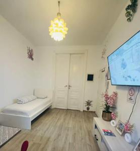 a white room with a bed and a projection screen at Modern & Comfortable City Center Oasis~King Bed ! in Brussels