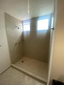 a bathroom with a shower with a window at Casa Bilbao in Chiconcuac +27 photos