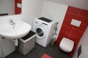 a bathroom with a washing machine and a sink at Apartments Brčić in Kaštela