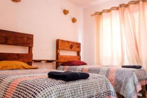 a bedroom with two beds and a window at Departamento-Rinconcito Uxmal in Playa del Carmen +45 photos