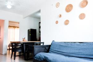 a living room with a couch and a table at Departamento-Rinconcito Uxmal in Playa del Carmen