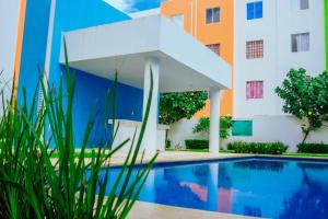 a swimming pool in front of a building at Departamento-Rinconcito Uxmal in Playa del Carmen