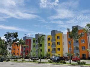 a row of colorful apartment buildings in a parking lot at Departamento-Rinconcito Uxmal in Playa del Carmen
