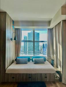 a bedroom with a large bed with a large window at Lux Aka Brickell Condo in Miami