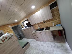 an aerial view of a kitchen in a tiny house at Cãbãnuţe - Lac Maleia in Dobreşti +10 photos