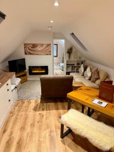 a living room with a couch and a table at Serafina Lodge in Leominster