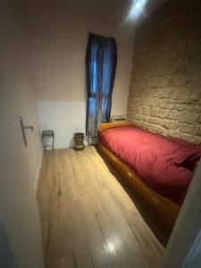 a bedroom with a red bed and a window at New apartment rue de Fontenay in Vincennes