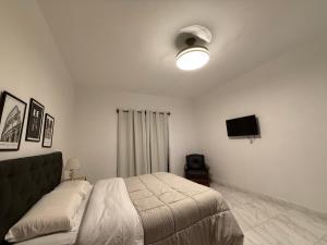 a bedroom with a bed and a flat screen tv at Departamento en Zona Norte A ESTRENAR con hermosa vista in Salta
