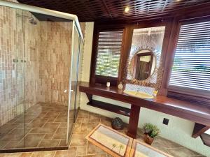 a bathroom with a shower and a sink and a mirror at Condomínio Marina Jaguari in Benfica +20 photos