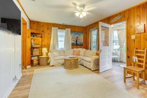 a living room with a couch and a ceiling fan at Cozy Cottage Just 2 Blocks From the River! in Colonial Beach