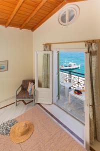 a living room with a door leading to a dock at Samaina Port Hotel in Karlovasi