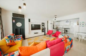a living room with a couch and a tv at Трехкомнатные апартаменты в жилом комплексе Caesar Beach D3 Flat4 in Boğaz