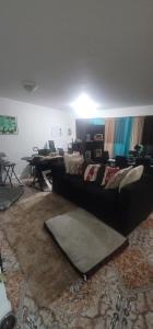 a living room with a couch and a table at Nassau Homestay in Opa-locka