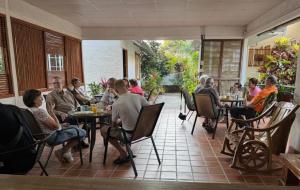 a group of people sitting at tables in a restaurant at Rainforest Yasmin Hotel in Santa Fé