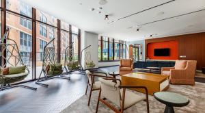 a living room with furniture and a tv and windows at The Stay 1 - Navy Yard Washington DC in Washington