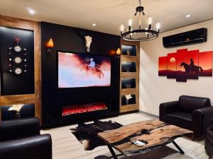 a living room with a fireplace and a tv at WildWest by 2ndHome in Rawalpindi