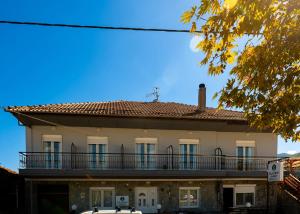an old building with a balcony on the side of it at Elation Rooms in Elatochori