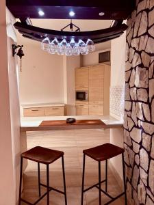 a kitchen with a counter and two stools in it at WildWest by 2ndHome in Rawalpindi